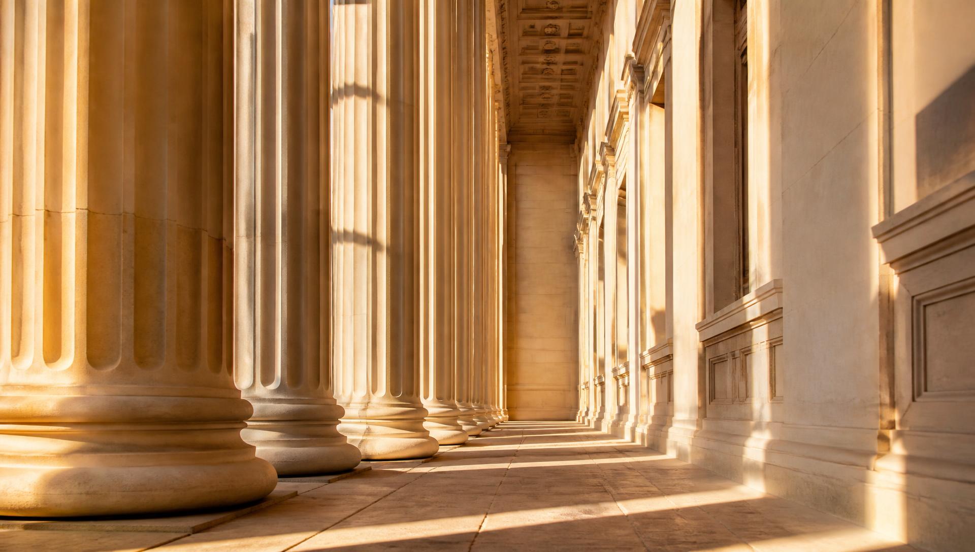 Sunlit limestone colonnade of a classical financial institution